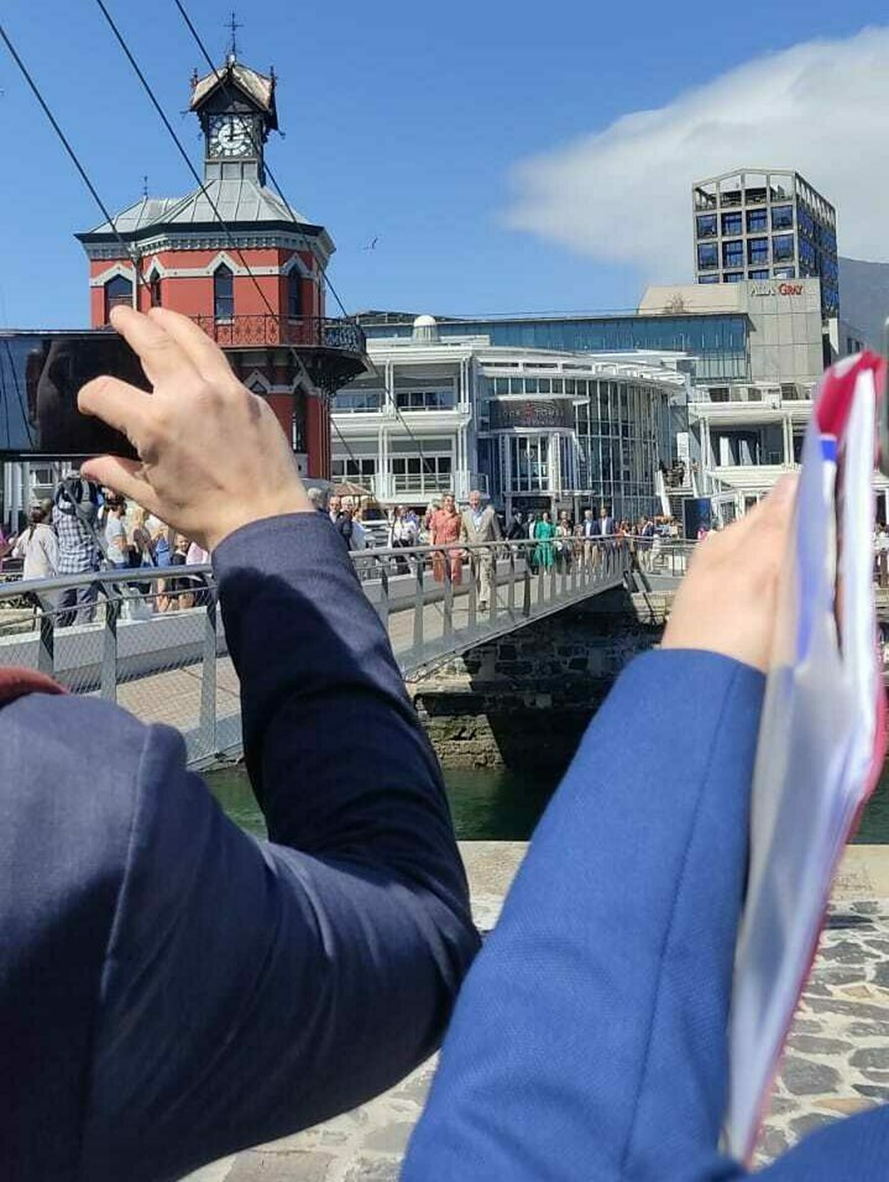 Their Majesties, the King and the Queen of the Belgians walk across the Swing Bridge at the V&A Waterfront